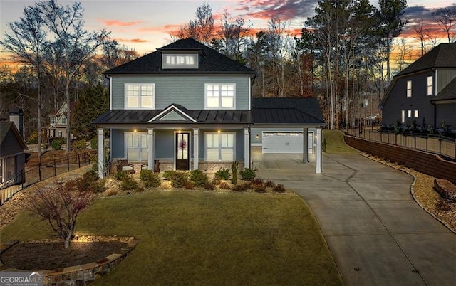 view of front of house featuring a garage and a lawn