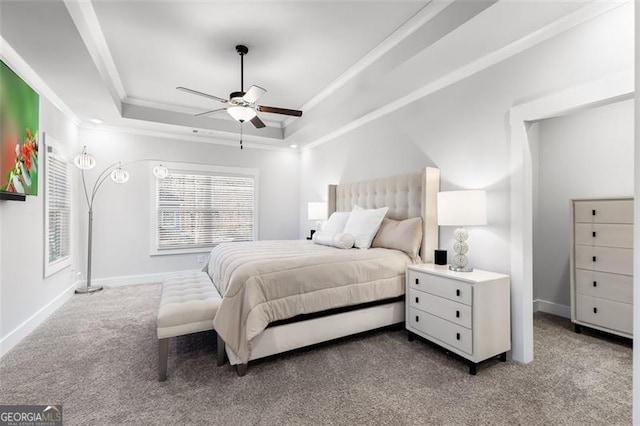 bedroom featuring ceiling fan, carpet flooring, crown molding, and a raised ceiling