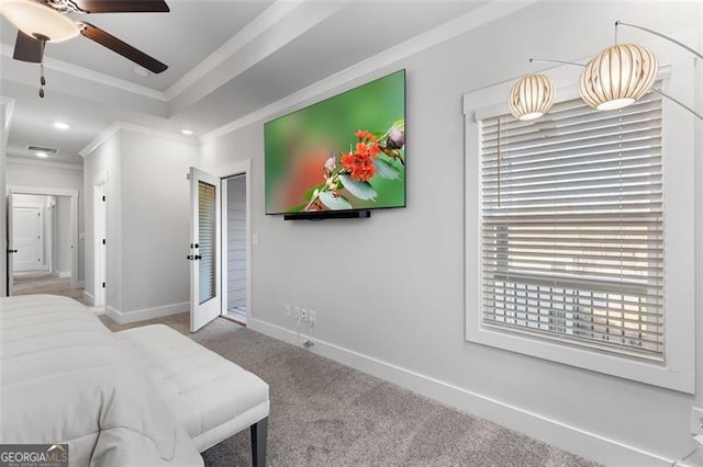 bedroom with a tray ceiling, ornamental molding, carpet floors, and ceiling fan