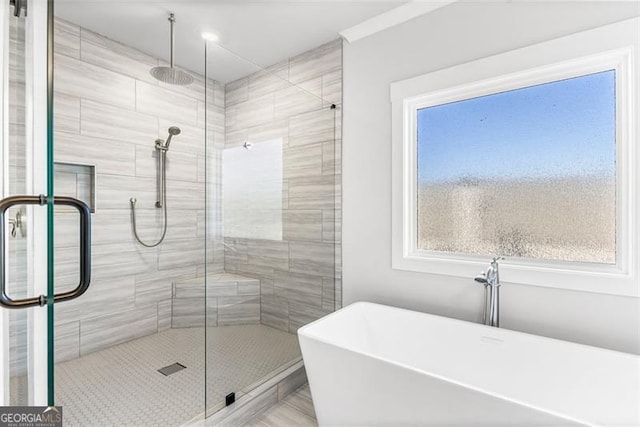 bathroom featuring shower with separate bathtub