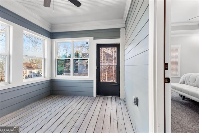 sunroom / solarium featuring ceiling fan