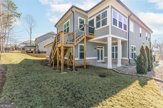 rear view of property with a yard, a patio area, and french doors