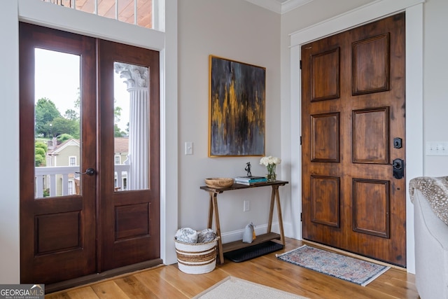 entrance foyer with light hardwood / wood-style flooring and french doors