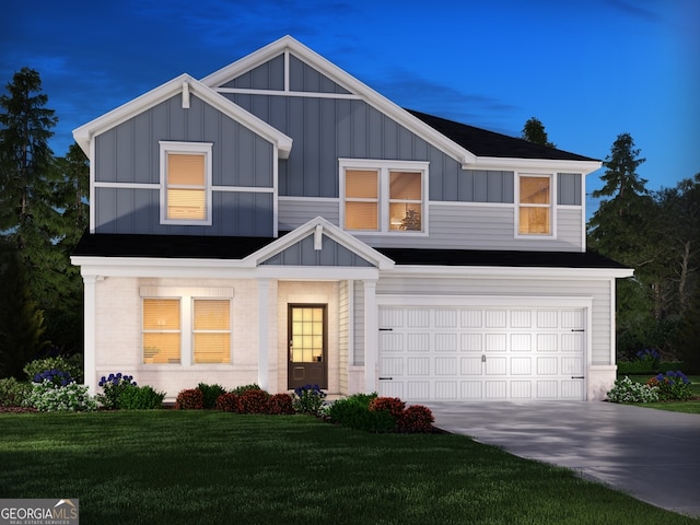 view of front of home with a garage and a lawn