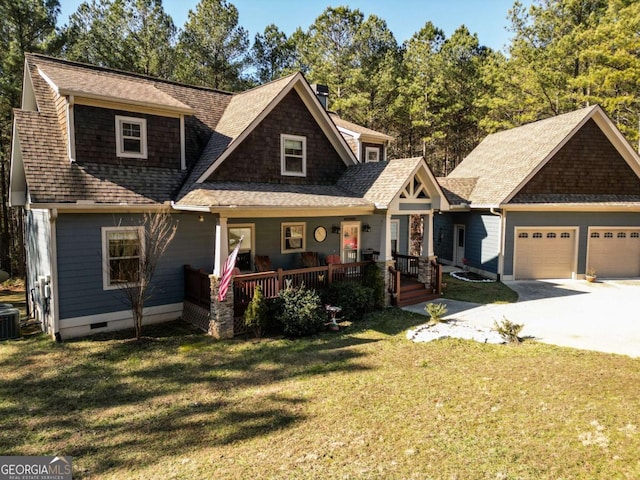 craftsman-style home featuring a garage, a front yard, central air condition unit, and covered porch