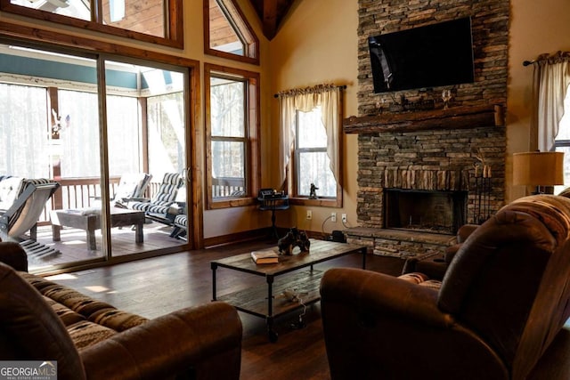 living room featuring a fireplace, wood-type flooring, and a high ceiling