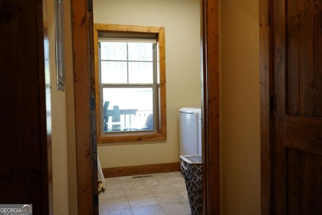 corridor featuring separate washer and dryer