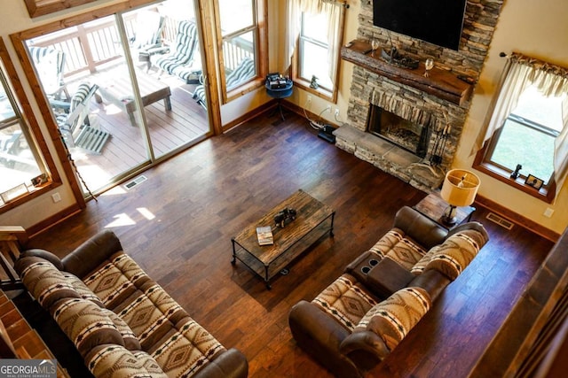 living room featuring a fireplace and dark hardwood / wood-style flooring