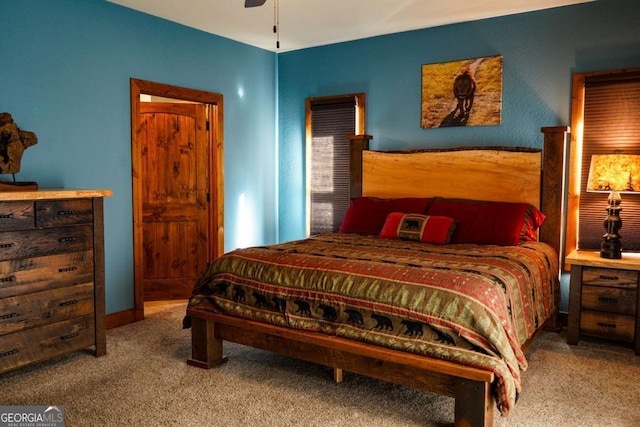 bedroom featuring ceiling fan and carpet