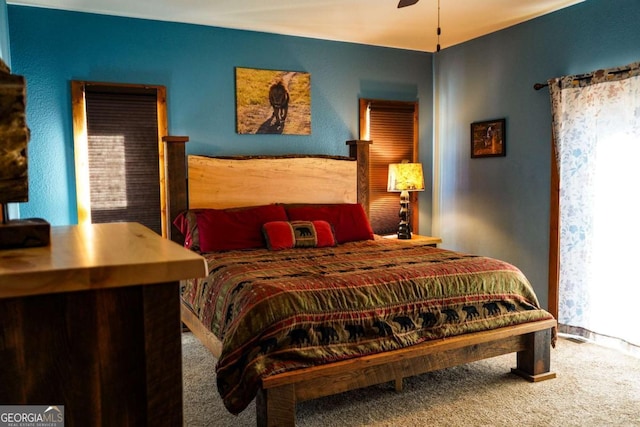 carpeted bedroom with ceiling fan