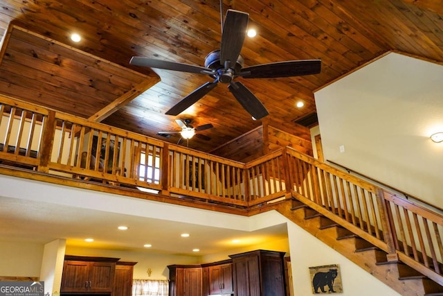 staircase with high vaulted ceiling and wooden ceiling