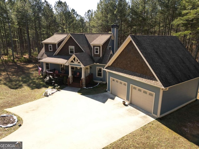 craftsman inspired home featuring a garage and covered porch