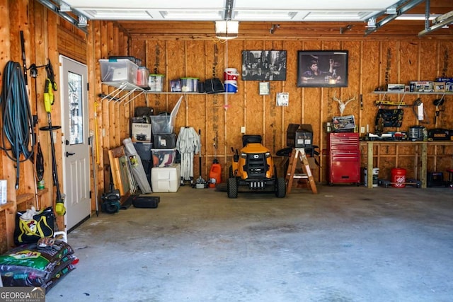 garage featuring a garage door opener and a workshop area