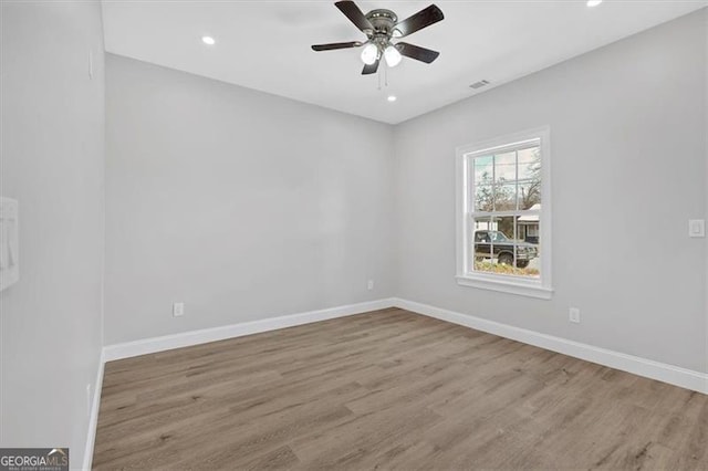 empty room featuring ceiling fan and light hardwood / wood-style flooring