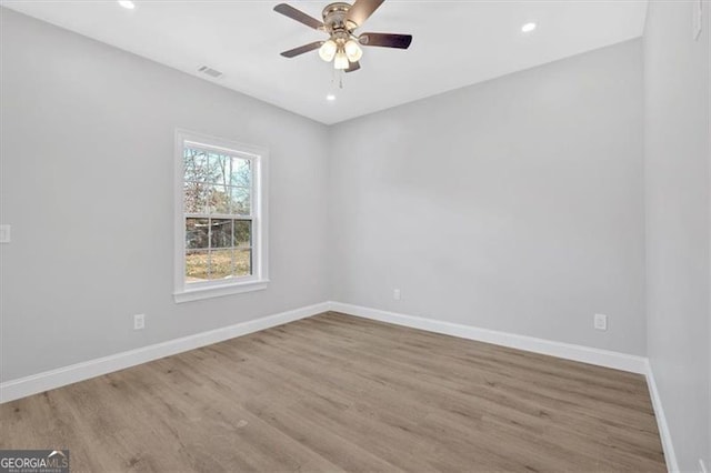 empty room featuring light hardwood / wood-style flooring and ceiling fan