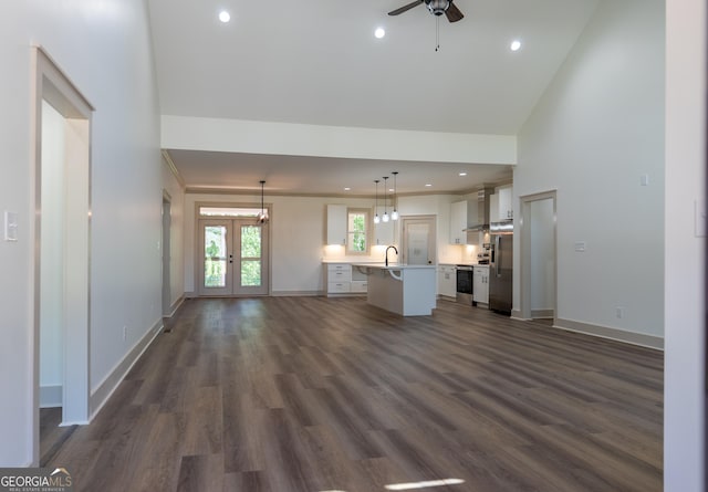 unfurnished living room with a ceiling fan, french doors, dark wood-type flooring, baseboards, and recessed lighting