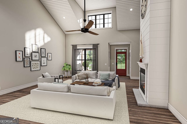 living area featuring a high ceiling, a fireplace, dark wood-style flooring, and a wealth of natural light