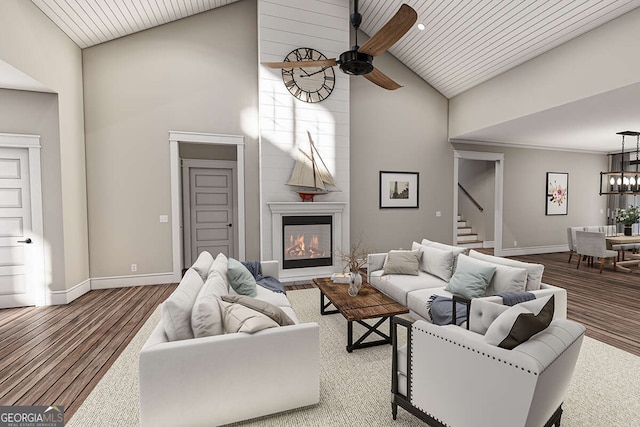 living room featuring wood finished floors, baseboards, high vaulted ceiling, a fireplace, and ceiling fan