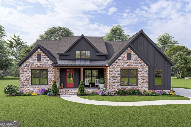 view of front of house featuring a front yard, a standing seam roof, brick siding, covered porch, and board and batten siding