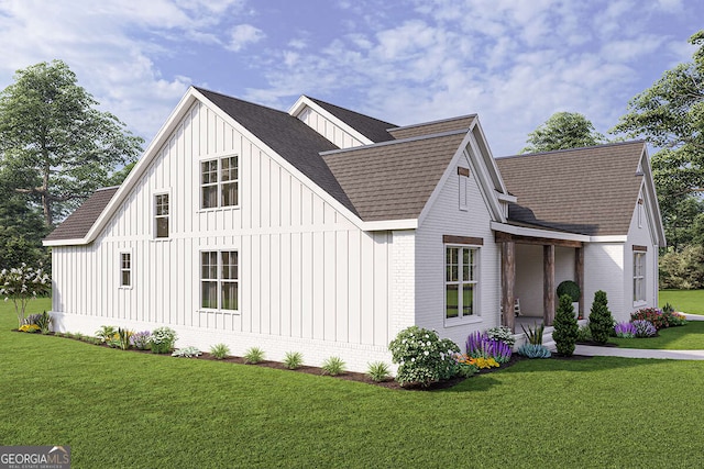 view of front of property with a front lawn, brick siding, board and batten siding, and roof with shingles