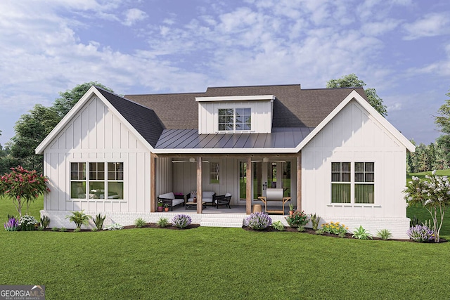 modern farmhouse style home featuring brick siding, board and batten siding, a front lawn, outdoor lounge area, and a standing seam roof