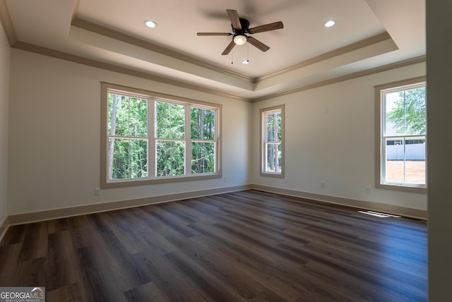 spare room with a raised ceiling, dark wood-style flooring, ceiling fan, crown molding, and recessed lighting