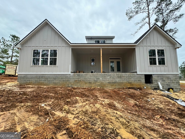 modern farmhouse featuring board and batten siding and french doors