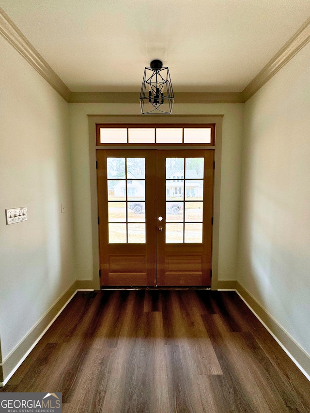 doorway with baseboards, dark wood finished floors, and ornamental molding