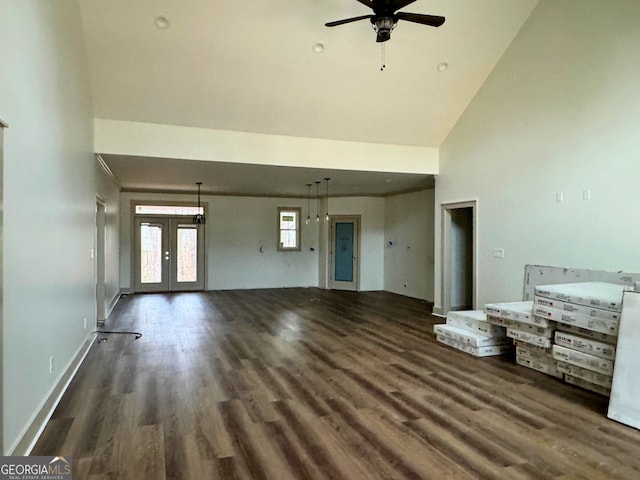 unfurnished living room featuring baseboards, french doors, wood finished floors, high vaulted ceiling, and a ceiling fan