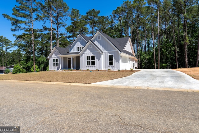 modern farmhouse with board and batten siding and driveway
