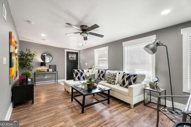 living room featuring hardwood / wood-style flooring and ceiling fan