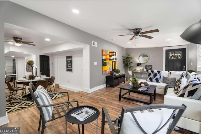 living room with hardwood / wood-style floors and ceiling fan