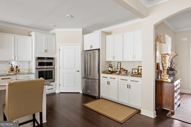 kitchen featuring backsplash, stainless steel appliances, dark hardwood / wood-style floors, and white cabinets