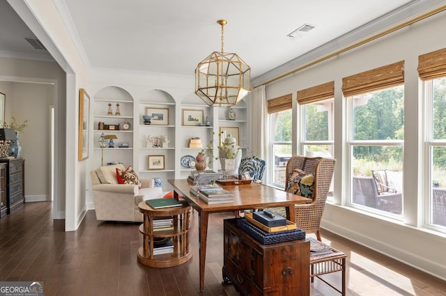 dining space with ornamental molding, hardwood / wood-style floors, built in features, and a notable chandelier