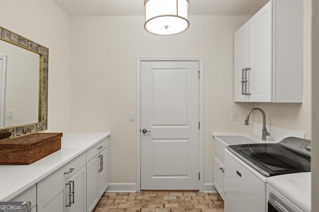 laundry area with cabinets, sink, and washing machine and clothes dryer