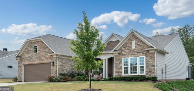 craftsman-style house featuring a garage and a front yard