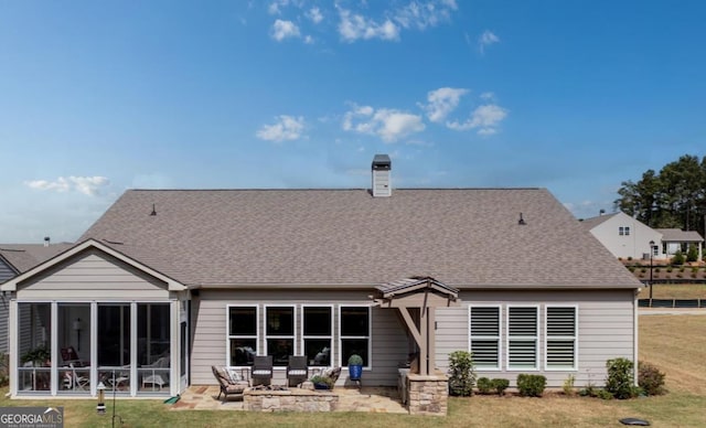 back of property featuring a yard, a sunroom, and a patio area