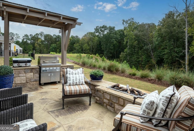 view of patio / terrace featuring area for grilling and an outdoor fire pit