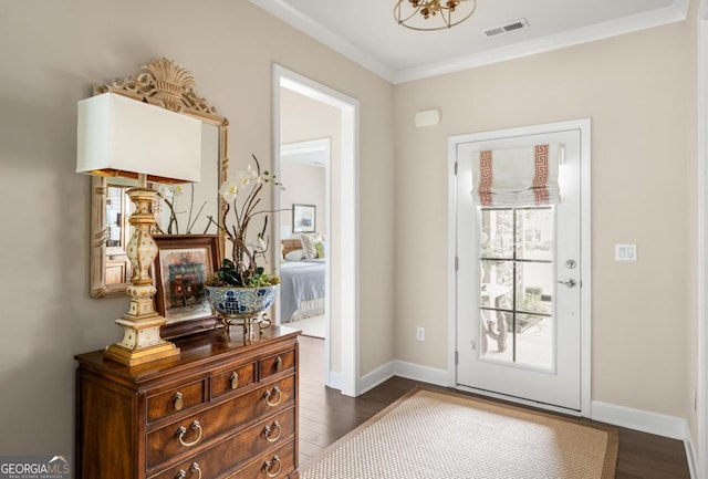 doorway to outside with crown molding and dark hardwood / wood-style floors