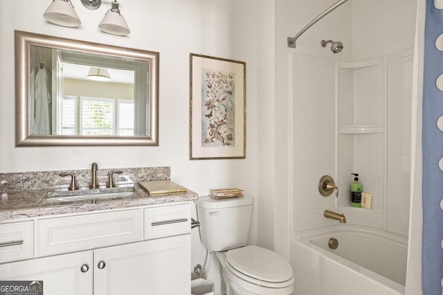 full bathroom with bathing tub / shower combination, vanity, and toilet