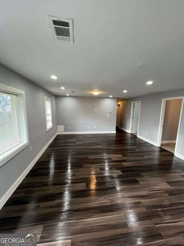 empty room with dark hardwood / wood-style flooring