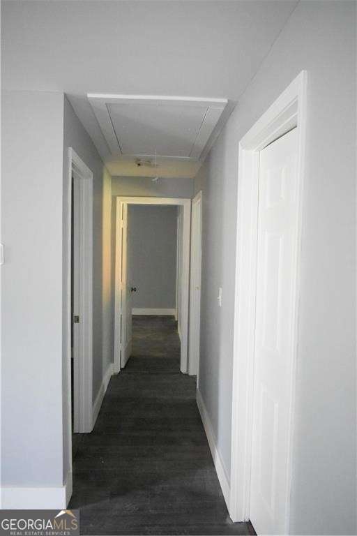 hallway with dark wood-type flooring