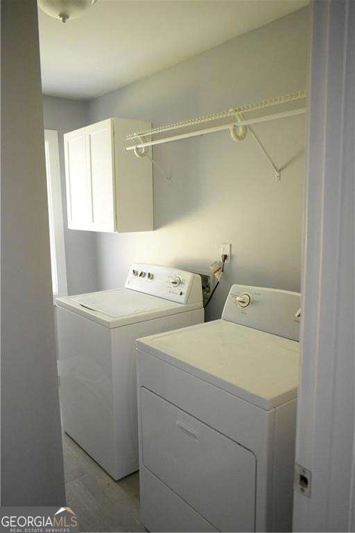 laundry room with cabinets and washer and dryer