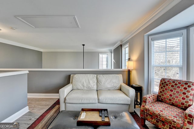 living room with ornamental molding, baseboards, and wood finished floors