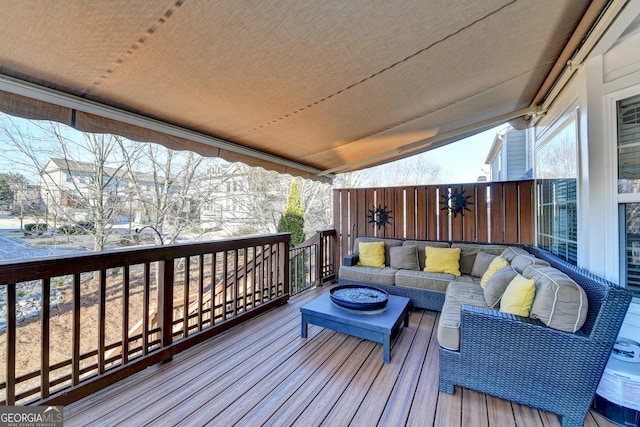 wooden deck with an outdoor living space