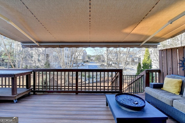 wooden terrace featuring an outdoor living space