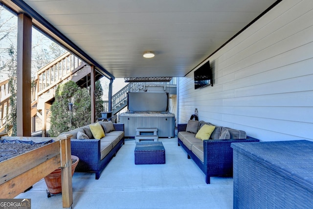 view of patio featuring a hot tub, stairway, and an outdoor living space