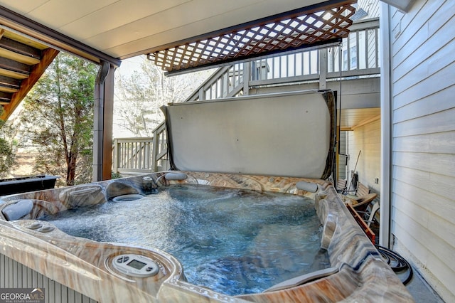 wooden terrace featuring a hot tub