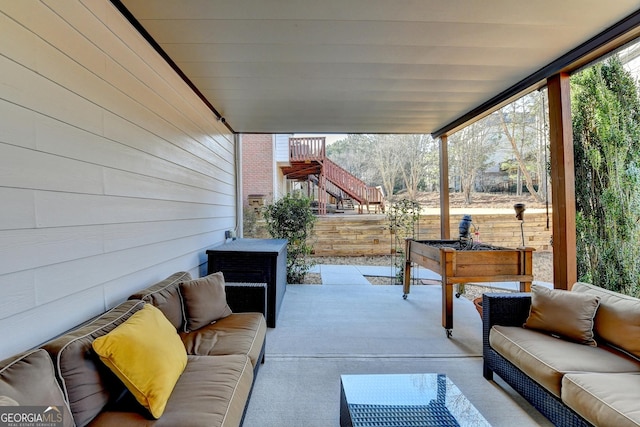 view of patio featuring fence and an outdoor living space