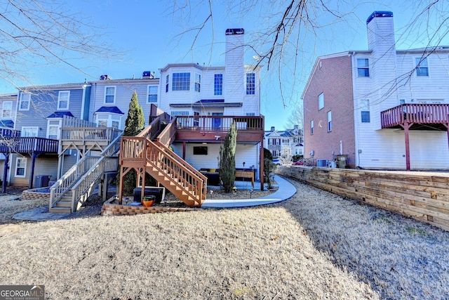 view of jungle gym featuring a residential view, stairway, a deck, and central AC